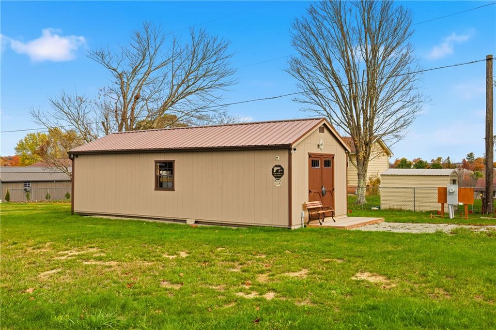 a white house that has a tree in front of it
