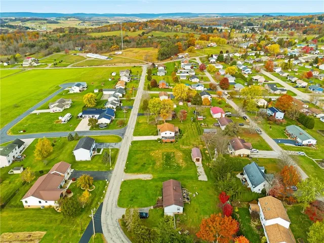 an aerial view of residential houses with outdoor space