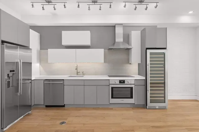 a view of a kitchen with a sink and dishwasher cabinets
