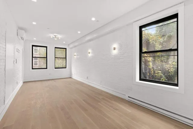 a view of a kitchen with a sink and a refrigerator