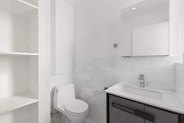 an empty room with windows and closet