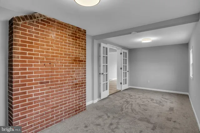 a view of a hallway with wooden floor and cabinet