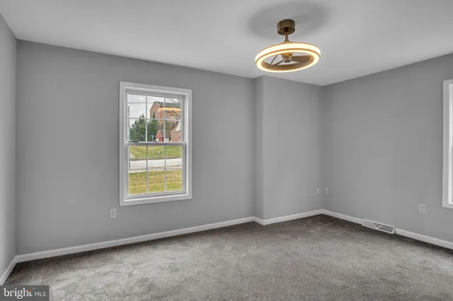 a bathroom with a sink a toilet and a window