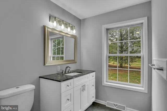 an empty room with a chandelier fan