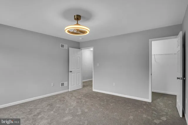 a view of an empty room with a fan