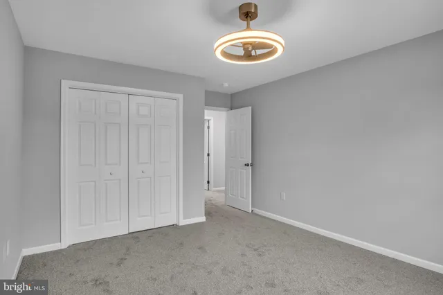 a bathroom with a granite countertop sink a mirror and a bathtub