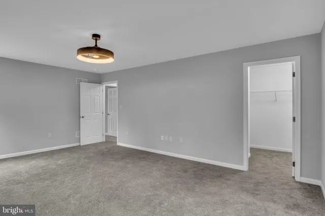 a view of a house with a yard covered in snow