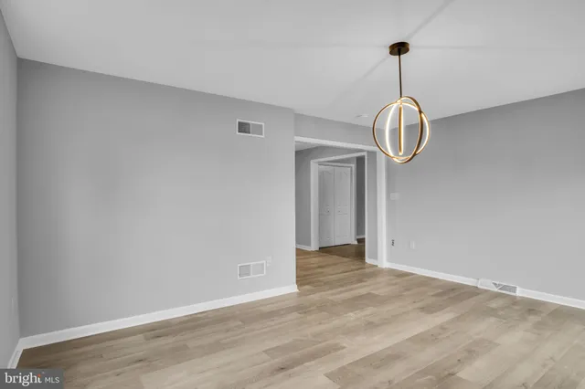 a view of empty room with a chandelier