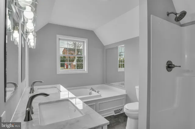 an aerial view of a houses with a yard