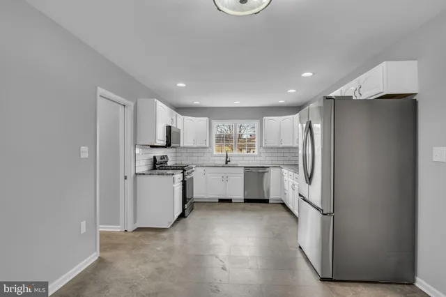 a kitchen with refrigerator and cabinets