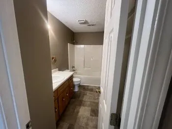 a bathroom with a double vanity sink and a mirror