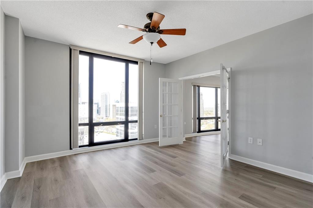 3475 Oak Valley Road Northeast, Unit 1930 Atlanta, GA 30326 - Photo 13 of 29 wooden floor in an empty room with a window