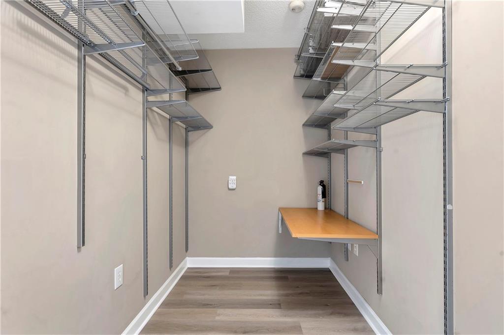 3475 Oak Valley Road Northeast, Unit 1930 Atlanta, GA 30326 - Photo 15 of 29 a view of a room with rack and wooden cabinet