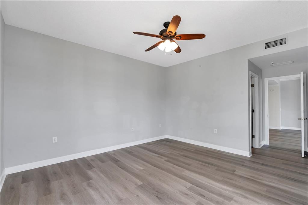3475 Oak Valley Road Northeast, Unit 1930 Atlanta, GA 30326 - Photo 17 of 29 a view of a big room with wooden floor closet and windows