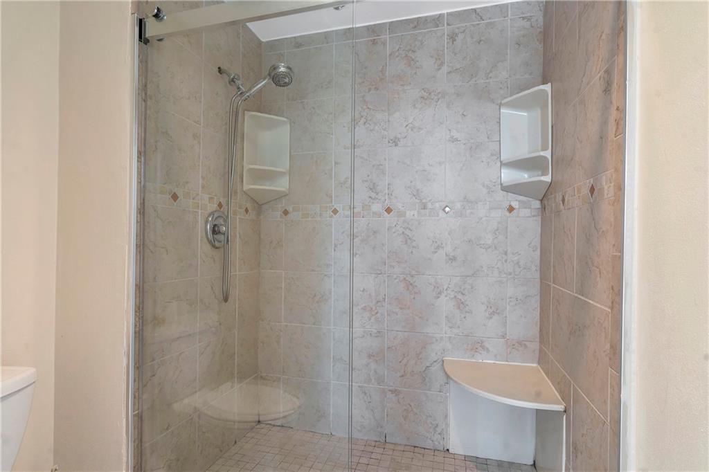 3475 Oak Valley Road Northeast, Unit 1930 Atlanta, GA 30326 - Photo 20 of 29 a bathroom with a shower and toilet