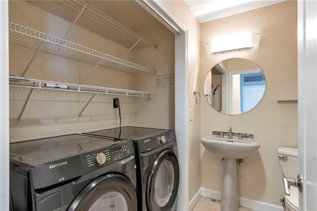a bathroom with a granite countertop sink a toilet and bathtub