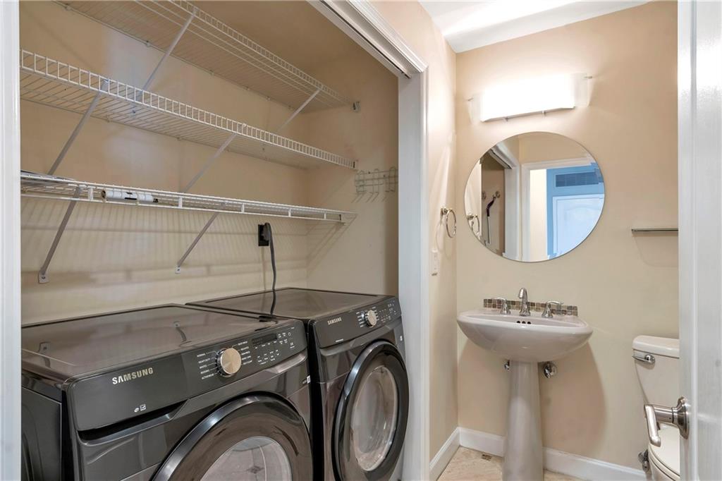 3475 Oak Valley Road Northeast, Unit 1930 Atlanta, GA 30326 - Photo 23 of 29 a bathroom with a sink mirror and toilet