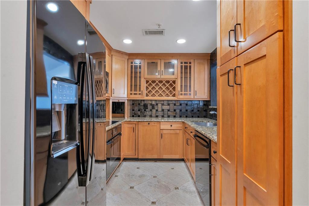 3475 Oak Valley Road Northeast, Unit 1930 Atlanta, GA 30326 - Photo 25 of 29 a kitchen with stainless steel appliances granite countertop a refrigerator and a sink