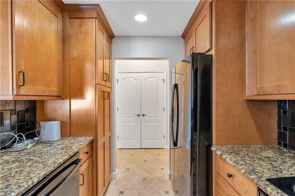3475 Oak Valley Road Northeast, Unit 1930 Atlanta, GA 30326 - Photo 29 of 29 a kitchen with granite countertop a refrigerator and a sink