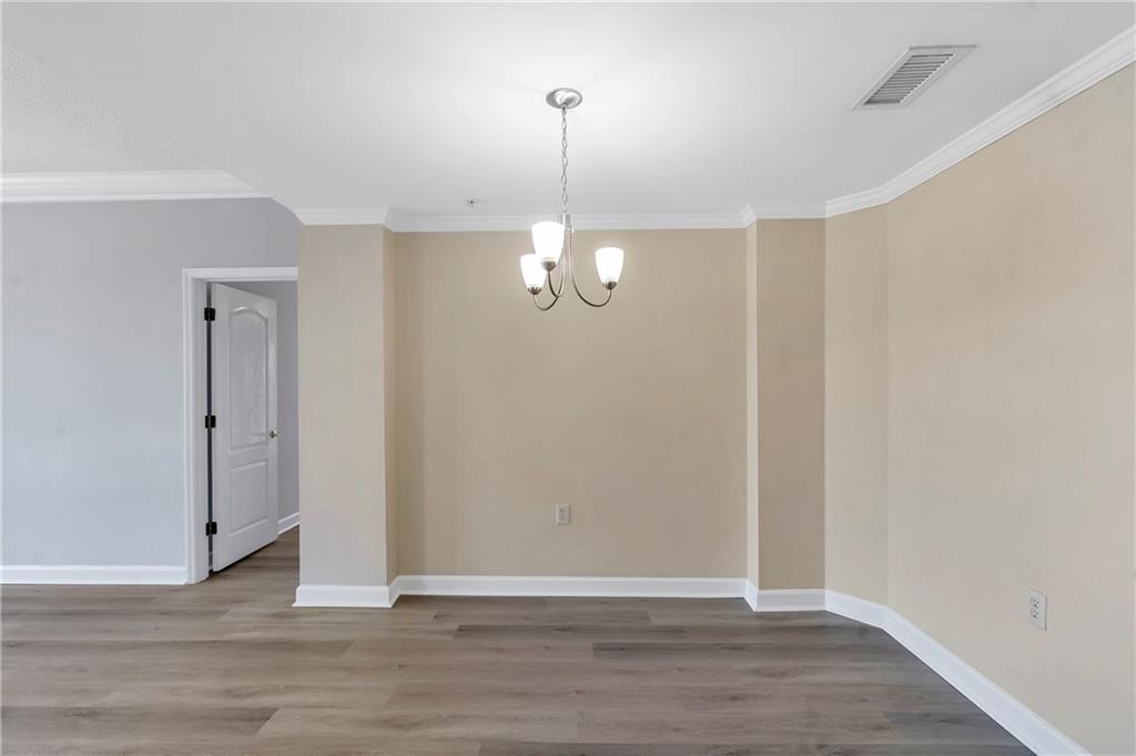 3475 Oak Valley Road Northeast, Unit 1930 Atlanta, GA 30326 - Photo 4 of 29 a view of a room with wooden floor and white walls