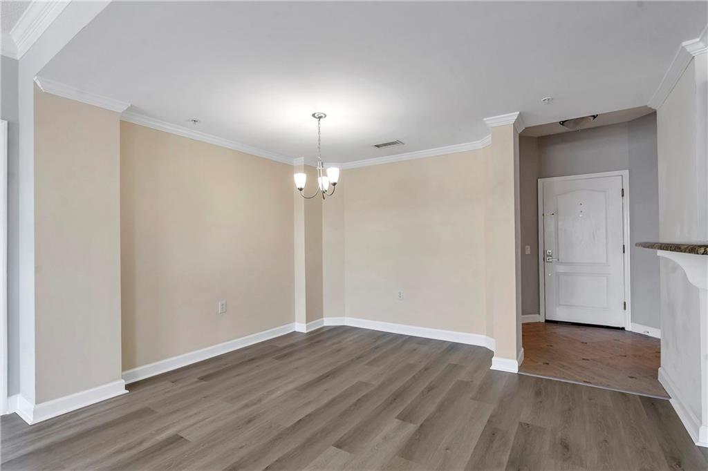3475 Oak Valley Road Northeast, Unit 1930 Atlanta, GA 30326 - Photo 5 of 29 wooden floor in an empty room with a window