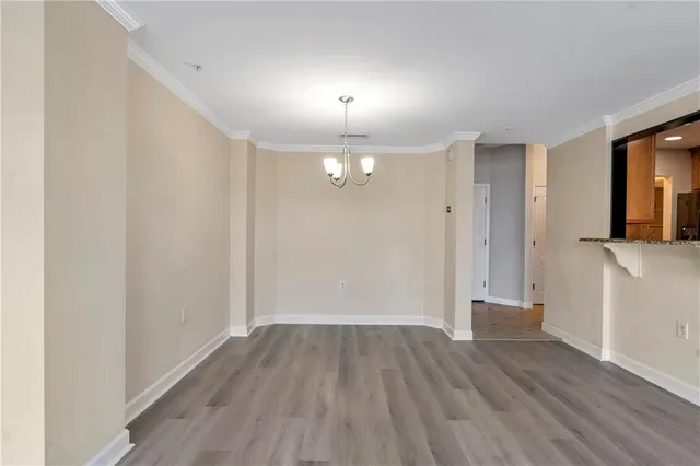 a view of a room with wooden floor and window