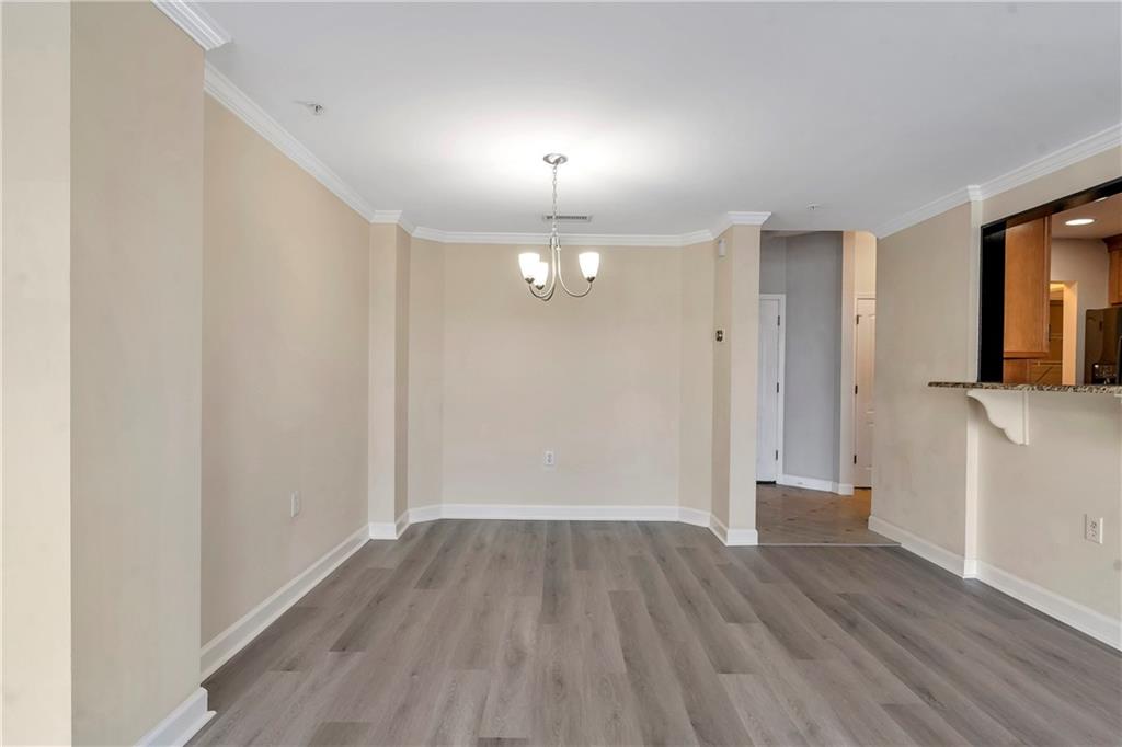 3475 Oak Valley Road Northeast, Unit 1930 Atlanta, GA 30326 - Photo 6 of 29 a view of empty room with wooden floor and fan