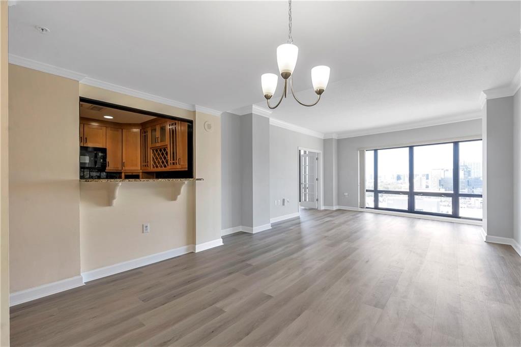 3475 Oak Valley Road Northeast, Unit 1930 Atlanta, GA 30326 - Photo 7 of 29 a view of a room with wooden floor and window