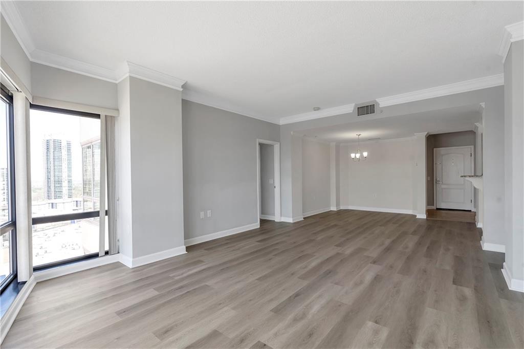 3475 Oak Valley Road Northeast, Unit 1930 Atlanta, GA 30326 - Photo 10 of 29 a view of empty room with wooden floor and fan