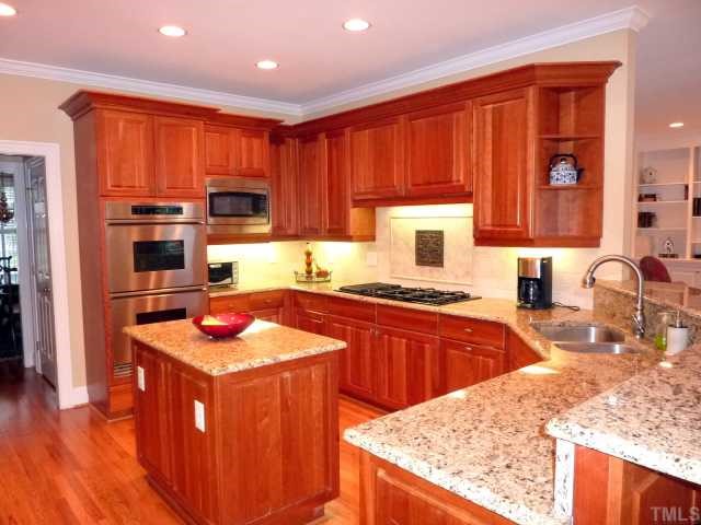 4617 White Chapel Way Raleigh, NC 27615 - Photo 2 of 12 a kitchen with stainless steel appliances granite countertop a sink stove and refrigerator