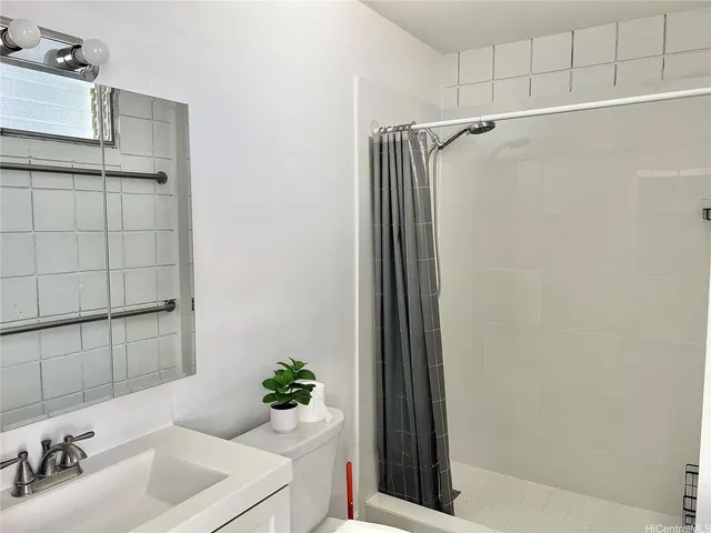 a bathroom with a sink a mirror and a shower