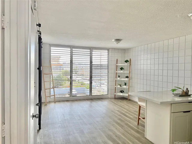 a kitchen with stainless steel appliances white cabinets and a stove top oven