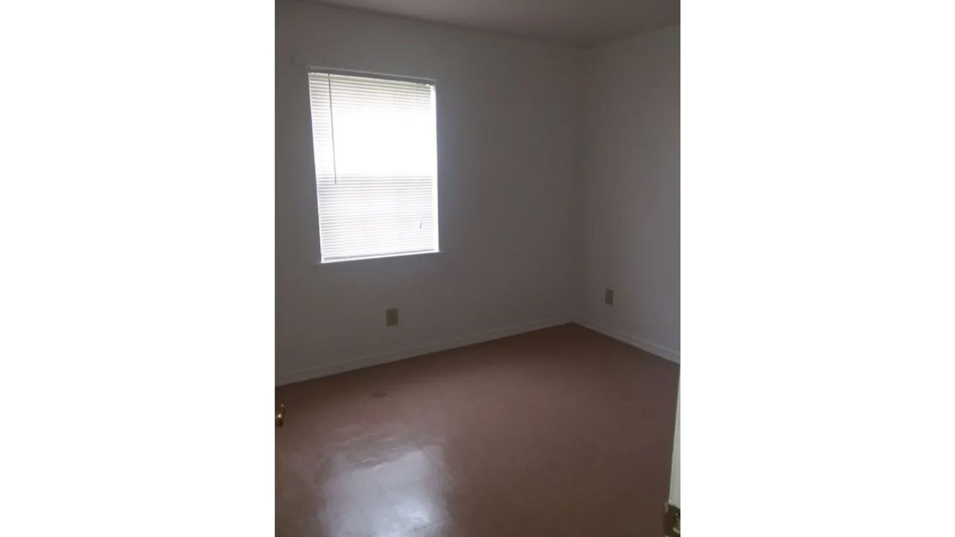 208 East Wells Street Madisonville, TX 77864 - Photo 4 of 7 a view of an empty room with a window
