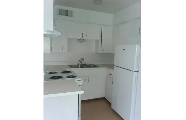 a utility room with cabinets washer and dryer
