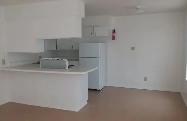 a utility room with cabinets washer and dryer