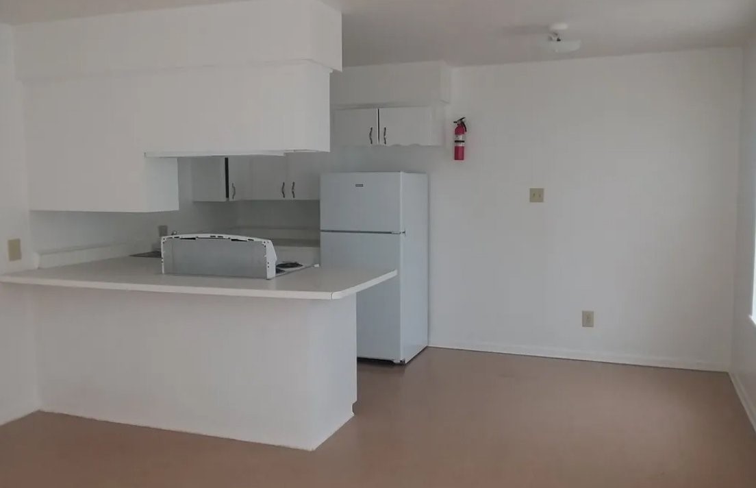 208 East Wells Street Madisonville, TX 77864 - Photo 7 of 7 a utility room with cabinets washer and dryer
