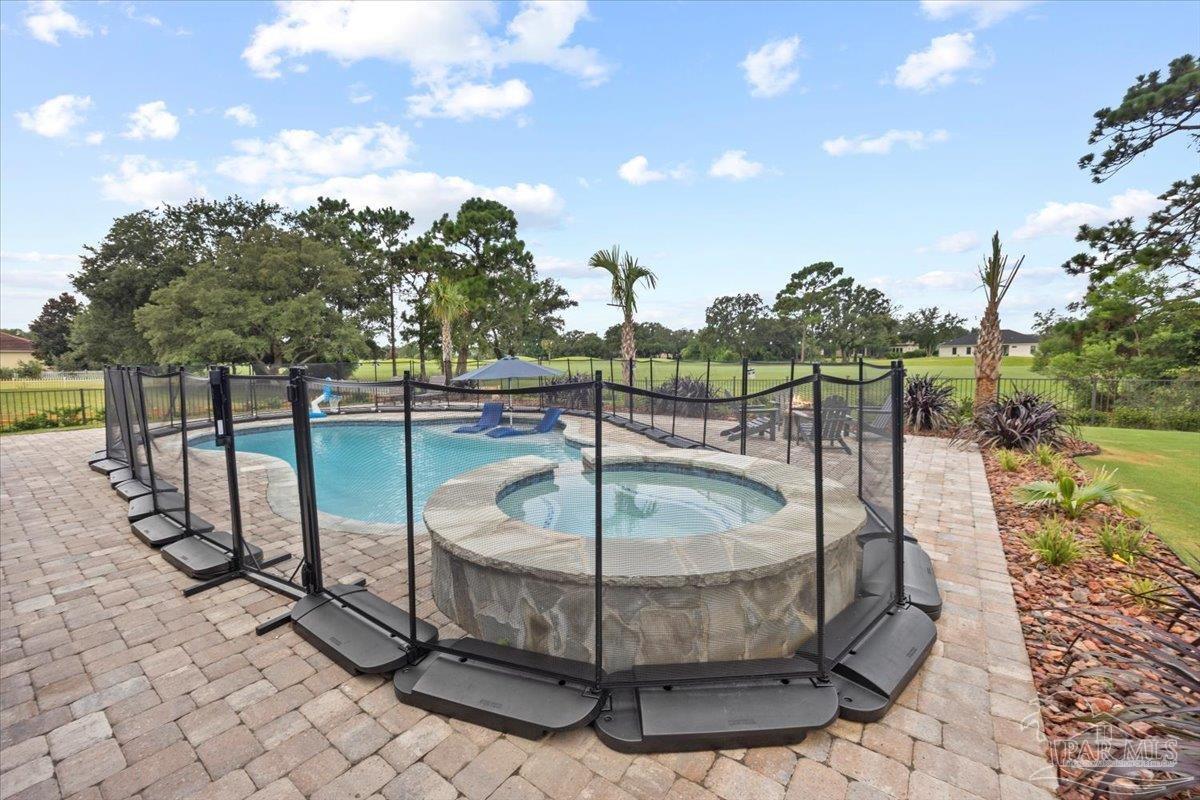 7191 Apples Way Navarre, FL 32566 - Photo 13 of 54 a view of a swimming pool with a sitting space