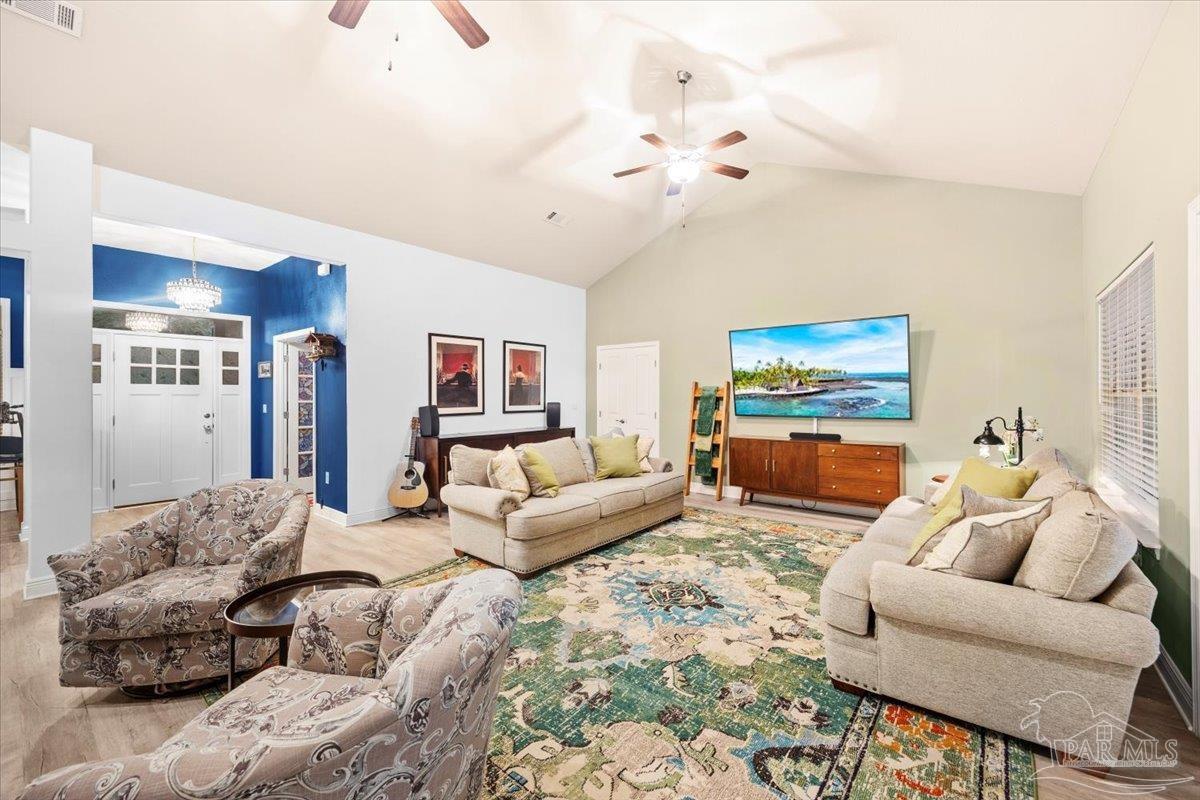 7191 Apples Way Navarre, FL 32566 - Photo 19 of 54 a living room with furniture and a flat screen tv