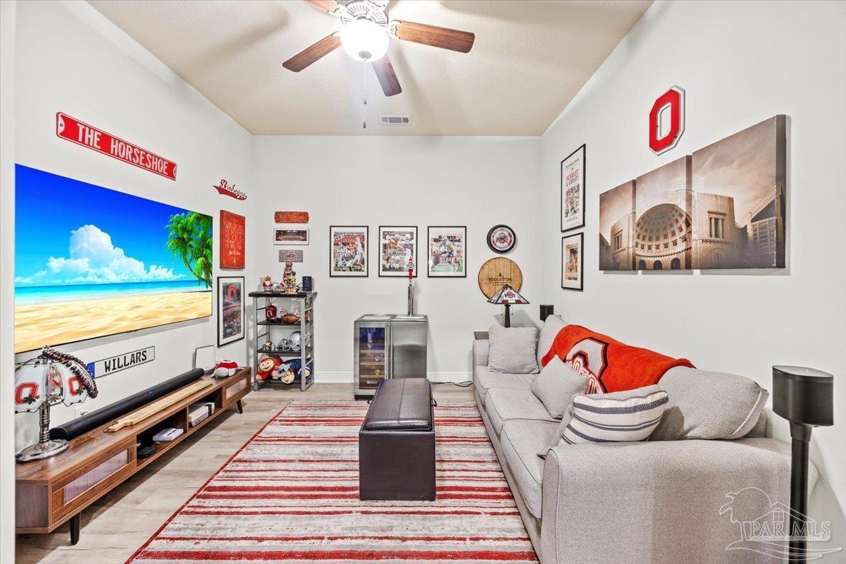 7191 Apples Way Navarre, FL 32566 - Photo 25 of 54 a bedroom with furniture and a flat screen tv