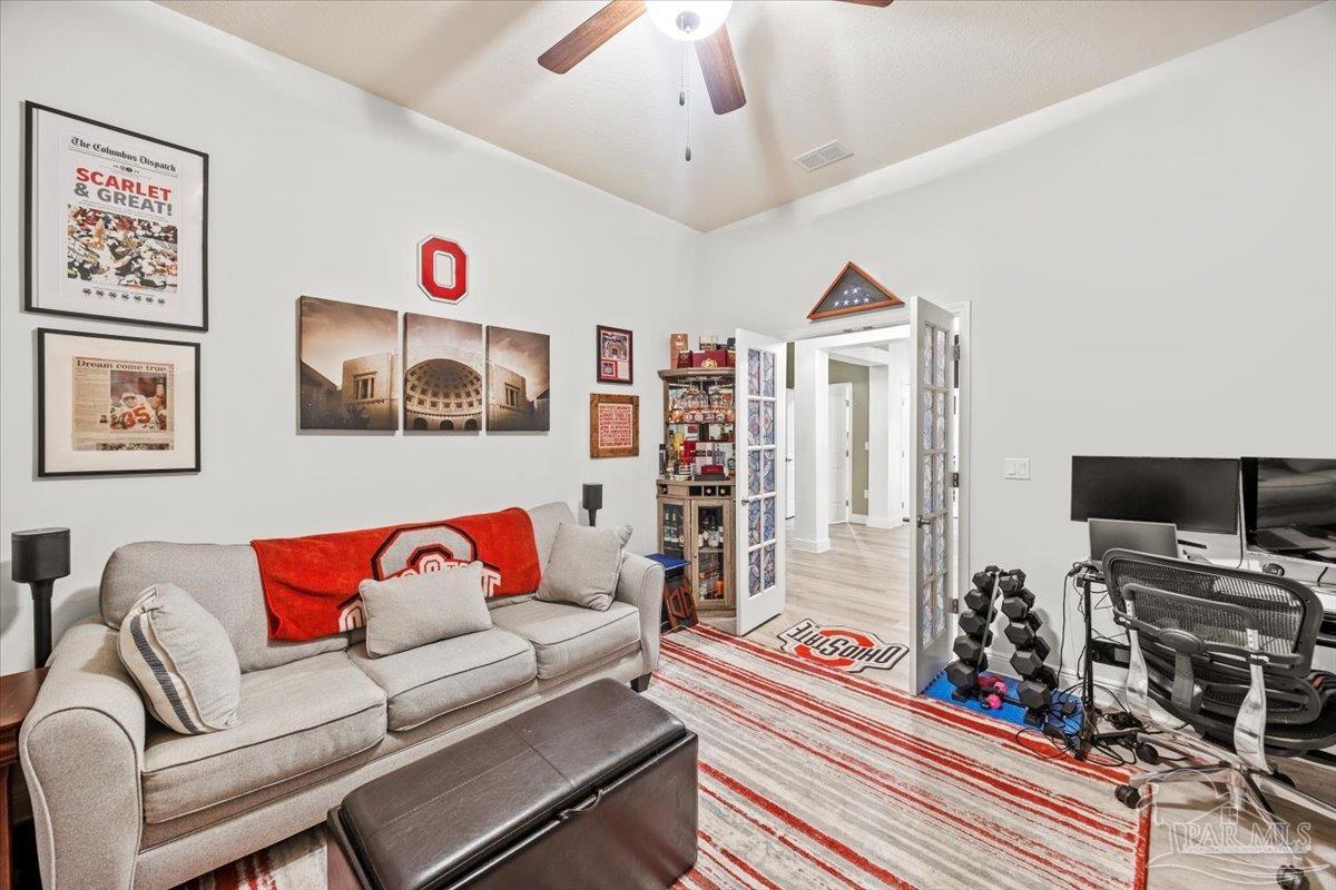 7191 Apples Way Navarre, FL 32566 - Photo 26 of 54 a living room with furniture and a flat screen tv