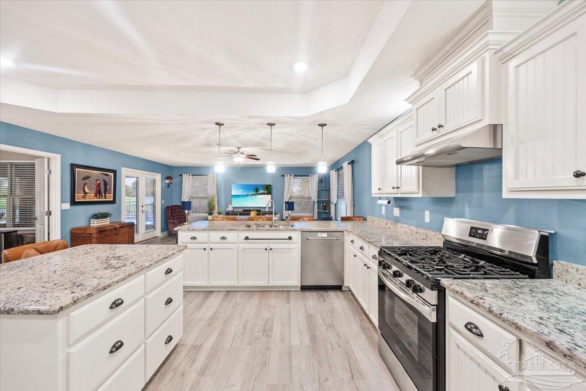 7191 Apples Way Navarre, FL 32566 - Photo 29 of 54 a kitchen with granite countertop cabinets stainless steel appliances and a counter space