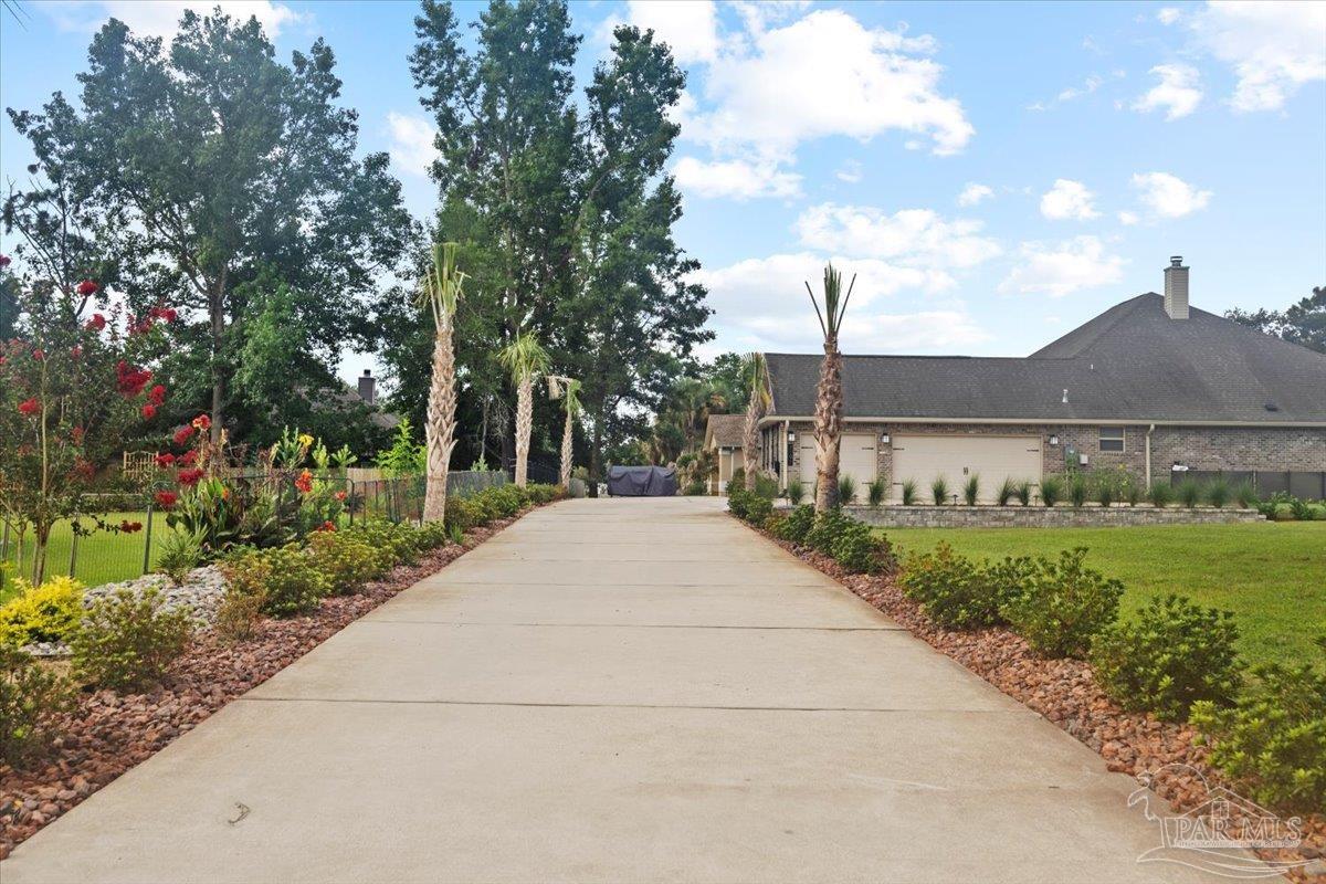 7191 Apples Way Navarre, FL 32566 - Photo 3 of 54 a view of a house with a yard