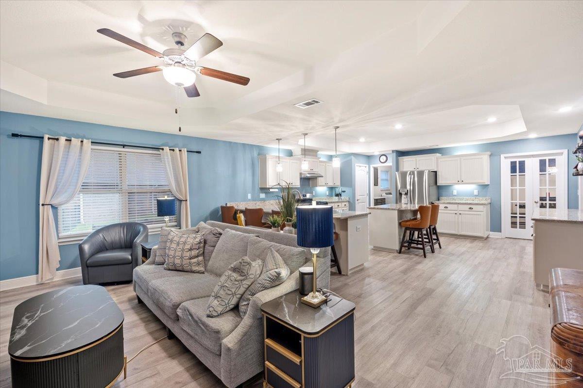 7191 Apples Way Navarre, FL 32566 - Photo 32 of 54 a living room with furniture and kitchen view