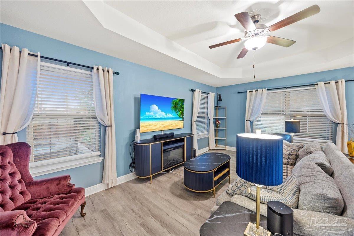 7191 Apples Way Navarre, FL 32566 - Photo 33 of 54 a living room with furniture and a flat screen tv