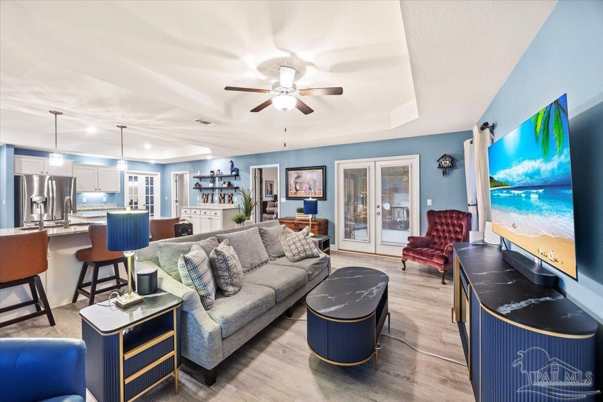 7191 Apples Way Navarre, FL 32566 - Photo 34 of 54 a living room with furniture and a flat screen tv