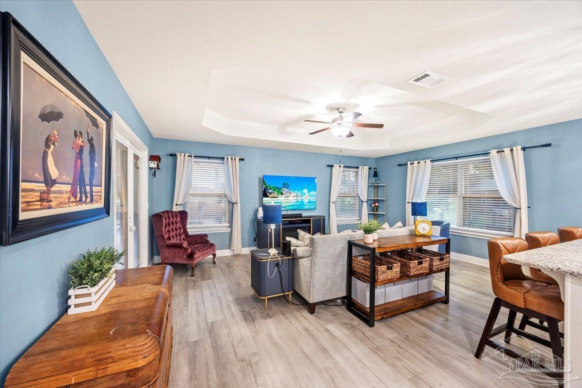 7191 Apples Way Navarre, FL 32566 - Photo 35 of 54 a living room with furniture and a flat screen tv