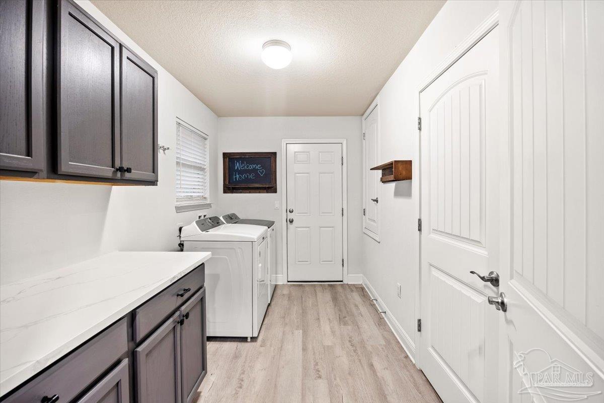 7191 Apples Way Navarre, FL 32566 - Photo 36 of 54 a view of a kitchen with a sink and dishwasher a refrigerator with wooden floor