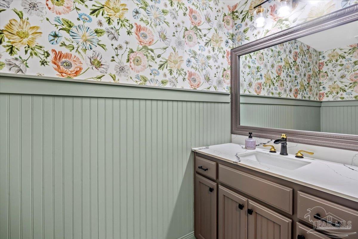 7191 Apples Way Navarre, FL 32566 - Photo 37 of 54 a bathroom with a sink and a mirror