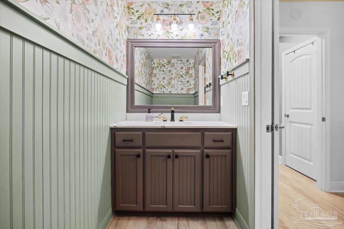 7191 Apples Way Navarre, FL 32566 - Photo 38 of 54 a bathroom with a sink a vanity and a mirror