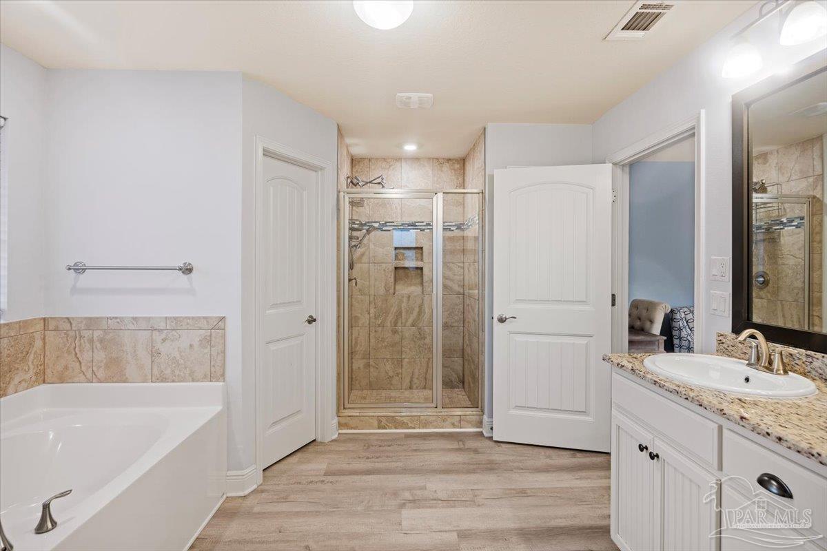 7191 Apples Way Navarre, FL 32566 - Photo 42 of 54 a bathroom with a tub sink shower and two mirror